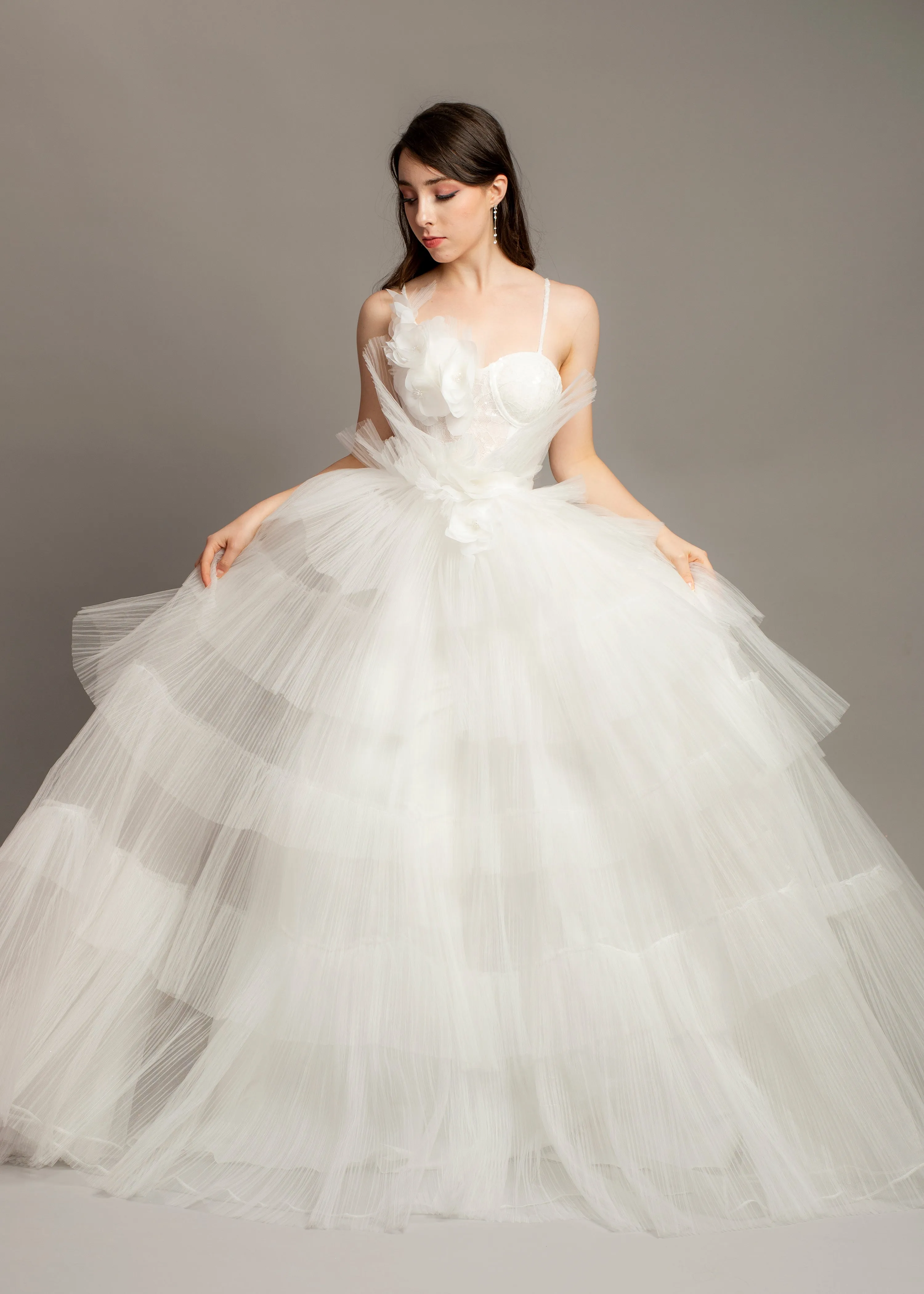 White wedding dress with asymmetrical 3D flower bustier top and puffy layered skirt