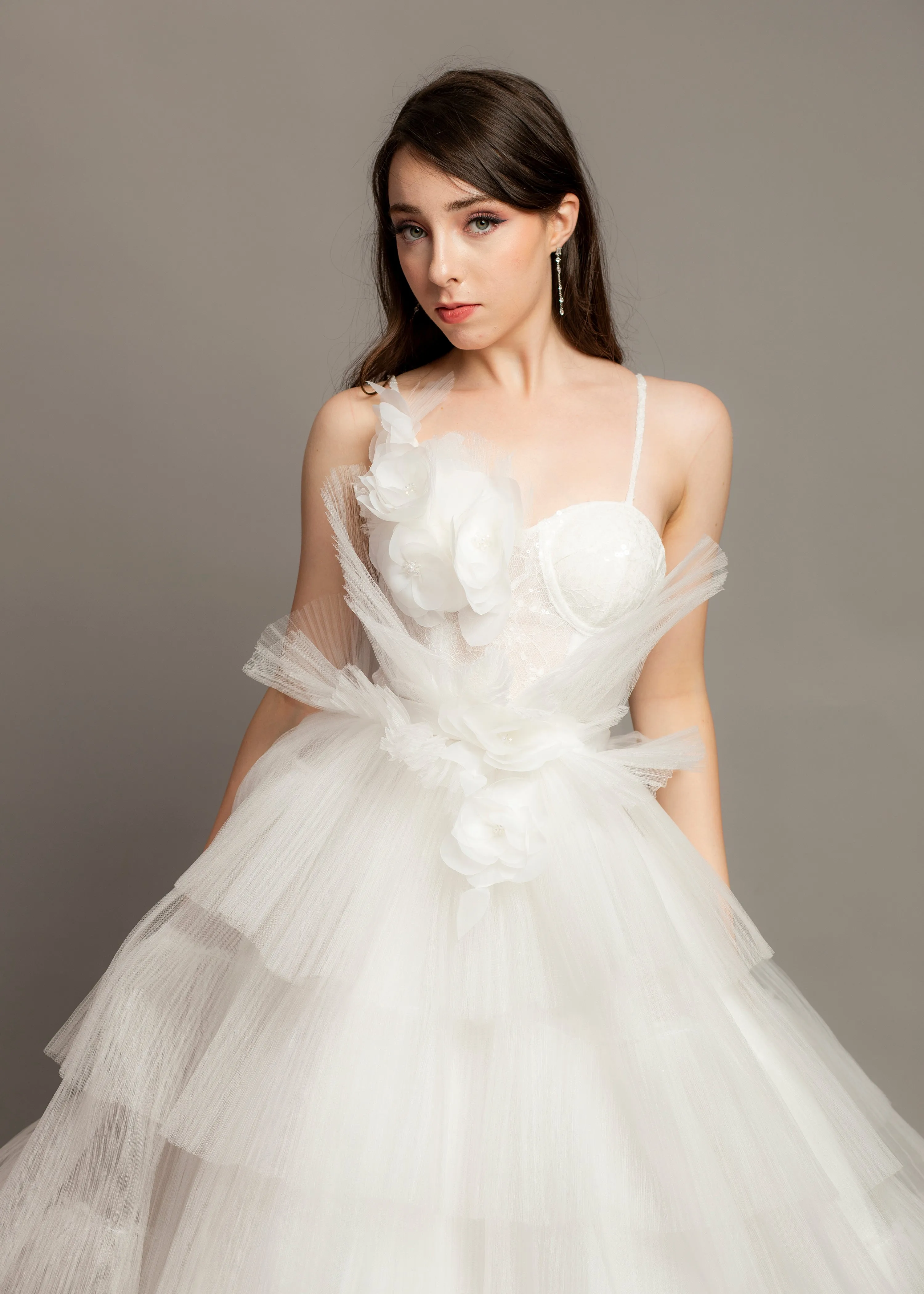 White wedding dress with asymmetrical 3D flower bustier top and puffy layered skirt