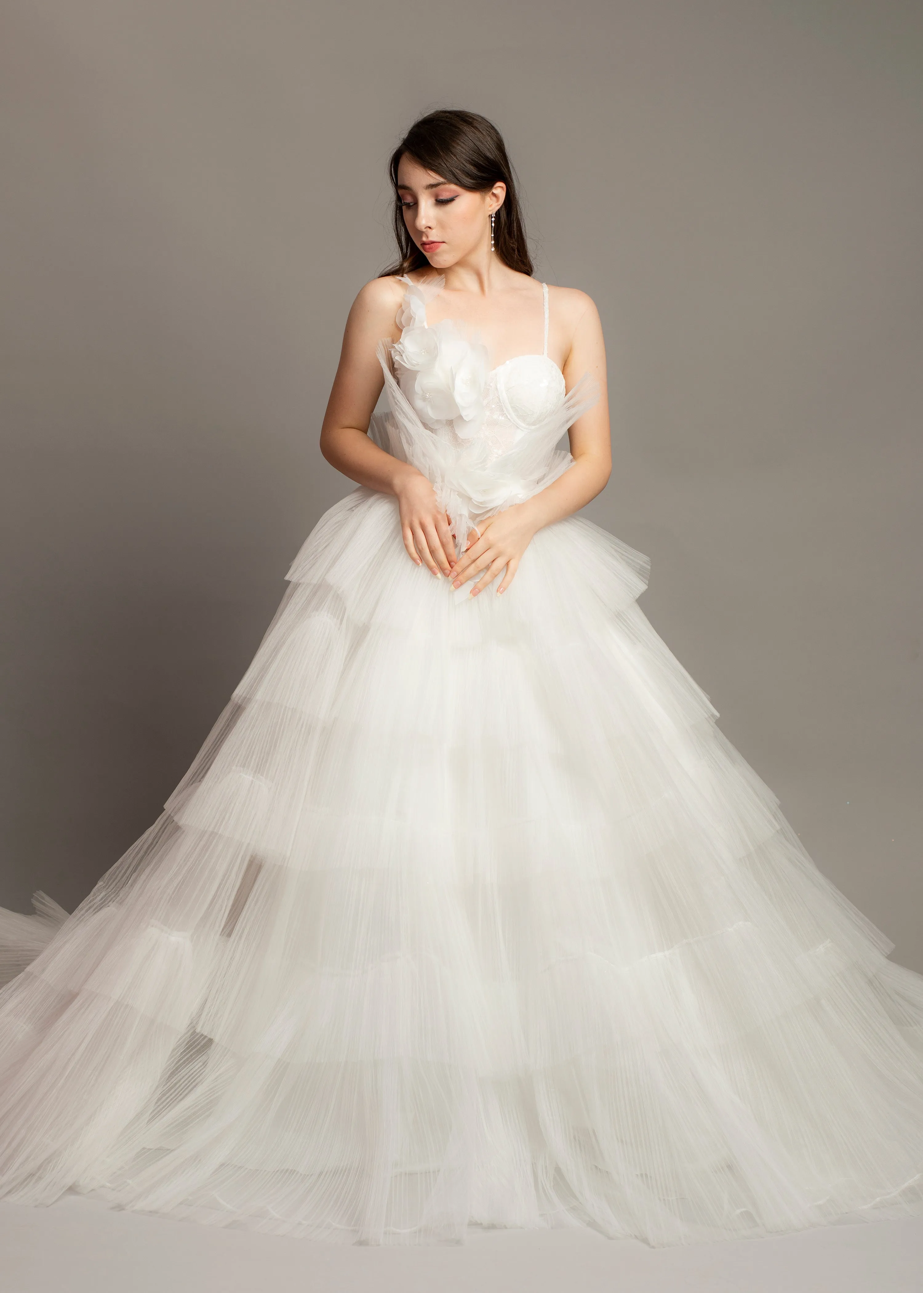 White wedding dress with asymmetrical 3D flower bustier top and puffy layered skirt