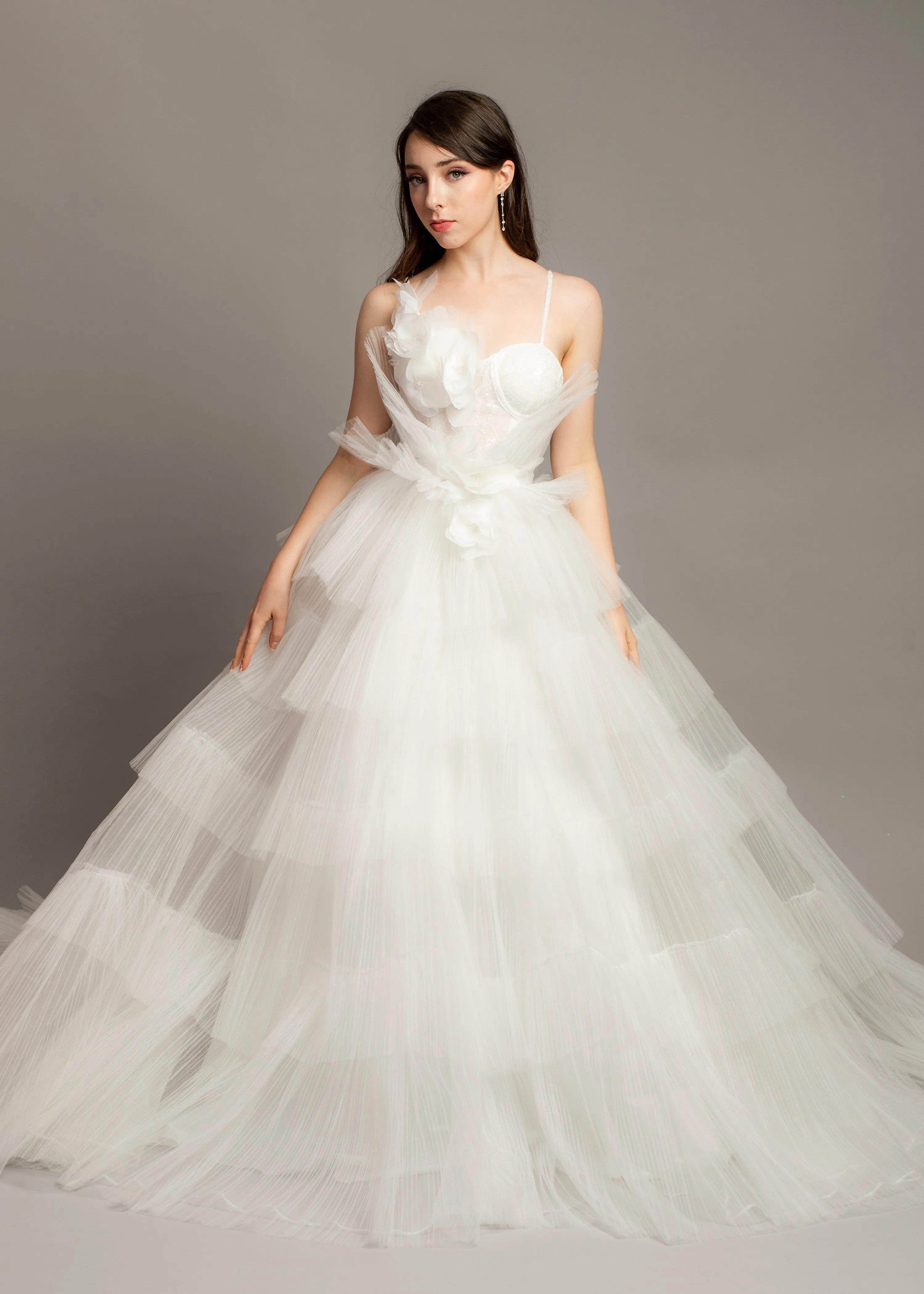 White wedding dress with asymmetrical 3D flower bustier top and puffy layered skirt