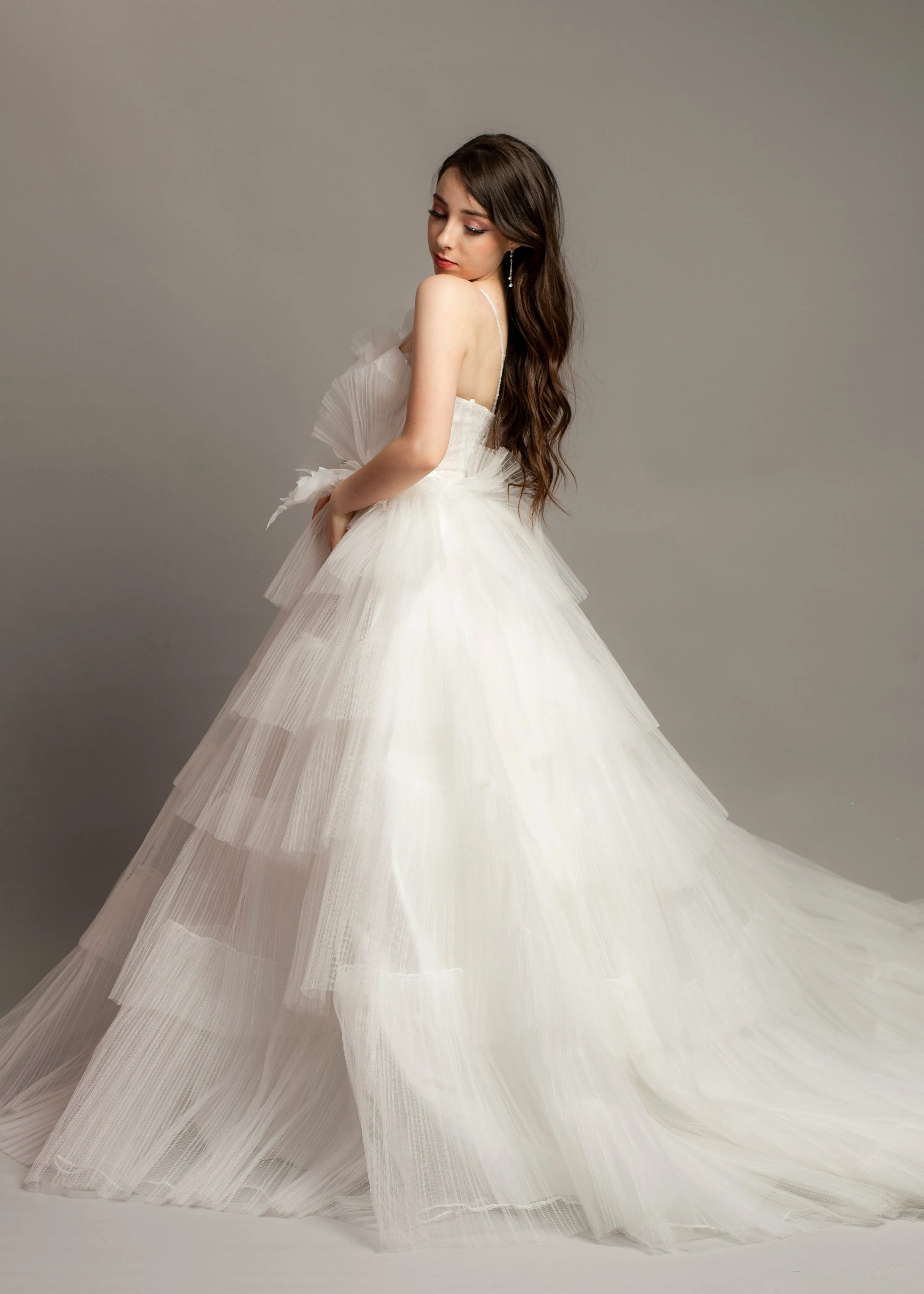 White wedding dress with asymmetrical 3D flower bustier top and puffy layered skirt