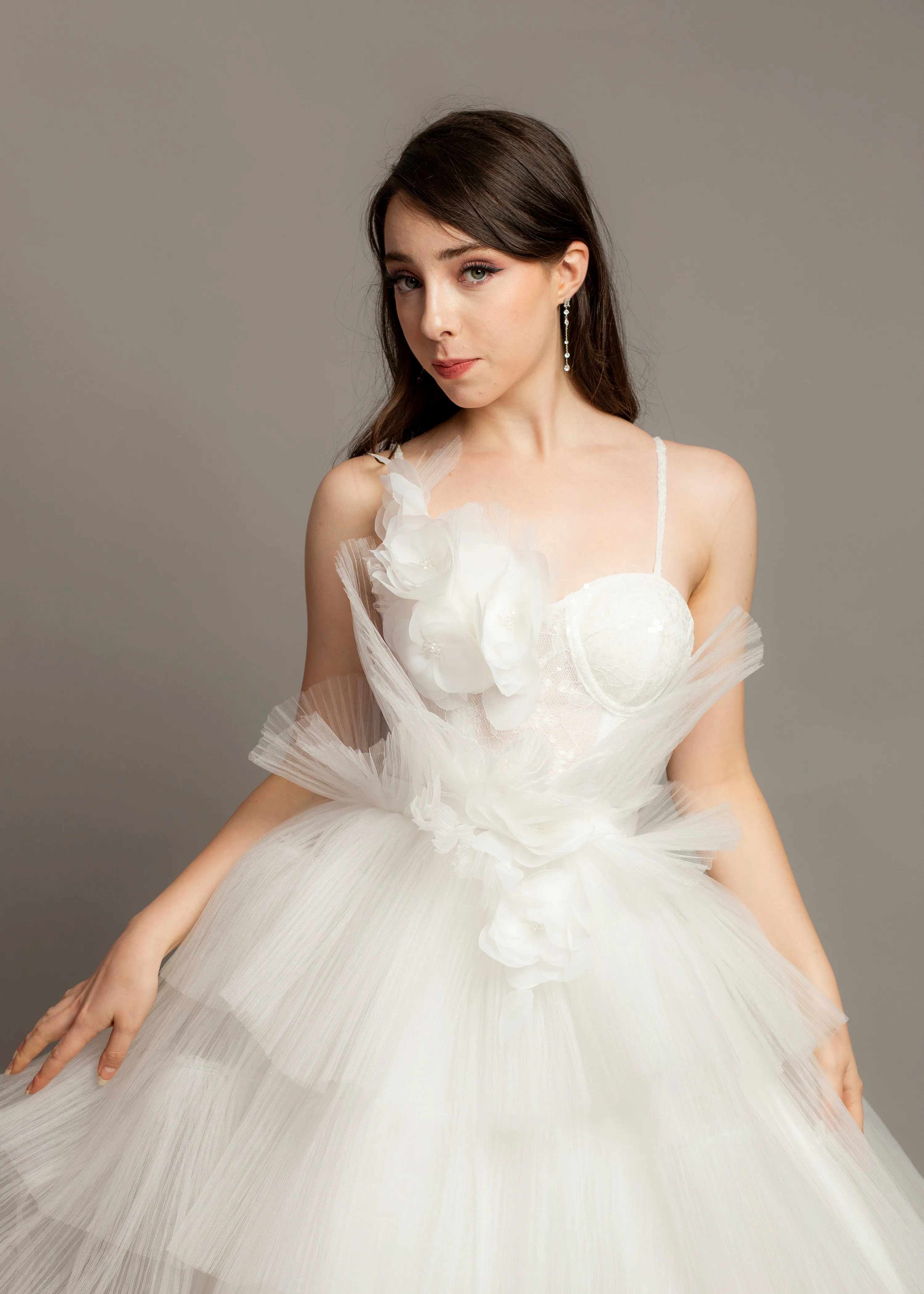 White wedding dress with asymmetrical 3D flower bustier top and puffy layered skirt